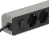 A close-up shot of a gray and black power strip with a switch and two outlets. Produktbild-Vorschau