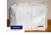 A white protective cover for a sewing machine, with the Brother logo visible. Produktbild-Vorschau