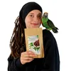 A woman holds a bag of bird food with a parrot on her shoulder. Voir les images du produit