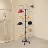 A multi-tiered black metal hat stand displaying various hats in a retail or display setting. Produktbild-Vorschau