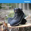 A pair of black work boots are displayed on a tree stump in a forest setting. Produktbild-Vorschau