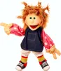 A puppet with red, messy hair, wearing a denim dress over a pink polka dot shirt, white pants, and colorful striped socks with black and red sneakers. Produktbild-Vorschau