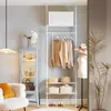 A well-organized bedroom or dressing area with a white telescoping clothing rack, a mannequin, a display cabinet, and a chair. Produktbild-Vorschau