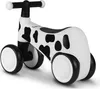 A white and black cow-print balance bike with black handlebars and wheels, shown on a white background. Náhled obrázku produktu