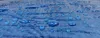 Close-up of water droplets on a blue tarp. Produktbild-Vorschau