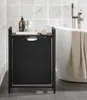 A laundry basket with a shelf in a bathroom next to a bathtub. Podgląd zdjęcia produktu