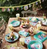 A table set for a Peppa Pig themed birthday party outdoors, with decorations, plates, cups, and cupcakes. Produktbild-Vorschau