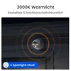 A security camera mounted on a wall at night, with warm light emanating from it. Produktbild-Vorschau