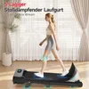 A woman is walking on a compact treadmill in a room with curtains and a plant. Produktbild-Vorschau