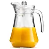 A clear glass pitcher filled with orange juice, presented on a white background. Podgląd zdjęcia produktu