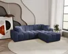 A modern living room with a blue sectional sofa, a large abstract artwork, and a decorative wall. Náhled obrázku produktu