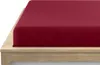 A close-up view of a burgundy fitted sheet on a wooden bed frame. Produktbild-Vorschau