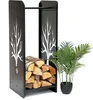 A black metal firewood rack with a tree design, filled with logs, stands next to a potted plant. Voir les images du produit