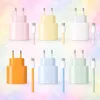 A collage of multiple USB-C chargers and cables in various pastel colors against a soft, bokeh-like background. Produktbild-Vorschau