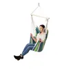 A woman sits in a striped hammock chair. Náhled obrázku produktu