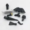 A collection of black steam cleaner attachments and a microfiber cloth are laid out on a white surface. Náhled obrázku produktu