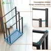 A black metal towel rack with three bars, shown in a room with a curtain in the background. Close-up insets highlight the construction and feet of the rack. Produktbild-Vorschau