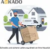 A delivery person is pushing a cart with a large box containing a bed towards a house, while another person stands at the door. Produktbild-Vorschau