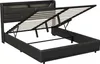 A black upholstered bed frame with the mattress support slats lifted, revealing storage space underneath. The headboard has a wood-grain accent. Náhľad obrázku produktu
