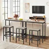 A living room scene with a bar table and stools in front of a sofa, with a TV and entertainment unit in the background. Produktbild-Vorschau