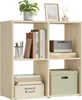 A light oak colored cube shelf unit with books, a plant, a picture frame, and storage boxes. Produktbild-Vorschau