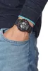A person's wrist wearing a black G-Shock watch with red accents, with their hand in their jeans pocket. Náhľad obrázku produktu