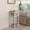 A bedside table next to a bed. Podgląd zdjęcia produktu