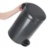 A hand is holding the lid of a black pedal trash can. Podgląd zdjęcia produktu