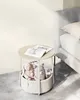 A bedside table with a basket containing stuffed animals, next to a bed. Náhled obrázku produktu