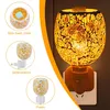 A collage of images showing a mosaic glass electric aroma lamp, including a top-down view, a side view, and a front view, alongside a larger image of the lamp plugged into a wall socket and lit. Produktbild-Vorschau