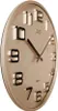 A close-up, angled view of a gold-colored analog wall clock with black numbers and hands. Náhľad obrázku produktu