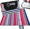 A folded and unfolded picnic blanket with stripes and a logo. Podgląd zdjęcia produktu