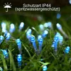Blue LED lights are placed in wet grass, suggesting outdoor use in rainy conditions. Produktbild-Vorschau