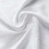 A close-up shot of white fabric with a textured weave, draped and folded. Anteprima dell’immagine prodotto