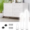 A white dresser with six drawers is shown, with three white hairpin legs of different sizes displayed in the foreground. Also shown are black floor protectors and screws. Produktbild-Vorschau