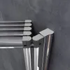 A close-up view of a shower enclosure's corner joint, showing the metallic frame and sealing mechanism against a textured gray wall. Produktbild-Vorschau