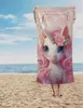 A person holding a unicorn-themed towel on a beach. Anteprima dell’immagine prodotto
