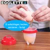 A person is cracking an egg into a silicone egg cooker. Produktbild-Vorschau