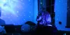 A person looking up at a starry sky projected onto the walls and ceiling of a room. Podgląd zdjęcia produktu