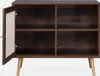 A dark wood cabinet with a cane door and light wood legs, shown from the front with the door open. Anteprima dell’immagine prodotto