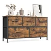 A dresser with five fabric drawers and a wooden top, decorated with vases, books, and a framed picture. Produktbild-Vorschau