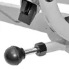 A close-up view of a black knob and a hexagonal nut on a metal exercise machine. Produktbild-Vorschau