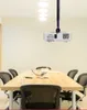 A conference room with a projector mounted on the ceiling above a wooden table and chairs. Voir les images du produit