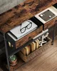 Close-up view of a wooden console table with drawers and shelves, displaying books, glasses, and a potted plant. Náhled obrázku produktu