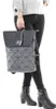 A person is holding a backpack and wearing black jeans and black boots. Produktbild-Vorschau