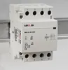 A white electrical component, likely a contactor or relay, is mounted on a metal rail against a light gray background. Produktbild-Vorschau