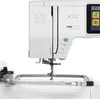 A close-up view of a white sewing machine with an embroidery hoop attached. Produktbild-Vorschau