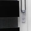 A close-up view of a black and white striped roller blind with a clear plastic pull cord mechanism. Produktbild-Vorschau