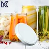 A white lid is placed in front of several jars of pickled vegetables, including cauliflower, carrots, and green beans. Produktbild-Vorschau