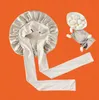 A satin bonnet and silk cocoons are laid out on an orange grid background. Voir les images du produit